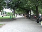 Brunette undresses in the midst of people