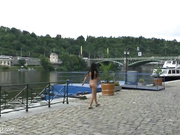 Brunette undresses in the midst of people