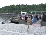 Brunette undresses in the midst of people