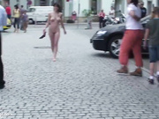 young woman with big breasts walks naked among the peop