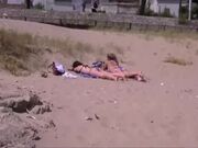 Two young girls taking a sunbath on the beach