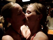 Twins kissing in bar