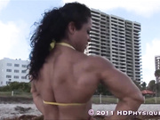 Muscle woman at the beach