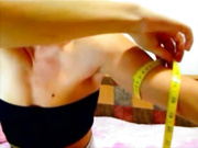 BEAUTIFUL GIRL FLEXING AND MEASURING HER BICEPS